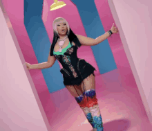 a woman in a corset and thigh high boots stands in a pink room