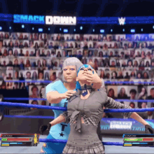 two women are wrestling in front of a crowd with the words smack down on the screen