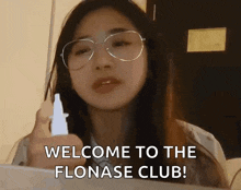 a woman is holding a nasal spray and saying welcome to the flonase club