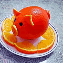 an orange shaped like a pig is sitting on a plate with orange slices .