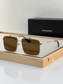 a pair of dolce & gabbana sunglasses sits on a white tray