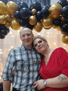 a man wearing a plaid shirt with the word ocean on it poses with a woman