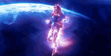 a woman in a superhero costume is flying through the air in front of a planet .