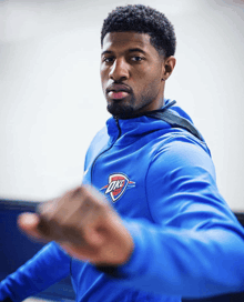 a man in a blue oklahoma city thunder jacket