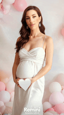 a pregnant woman in a white dress holds a heart in front of balloons