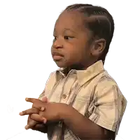 a young boy in a plaid shirt is making a funny face with his hands folded
