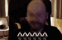 a man with a beard is surrounded by a row of monkeys holding hands