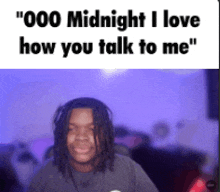 a man with dreadlocks is sitting in front of a computer screen with the words " 000 midnight i love how you talk to me "