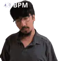 a man wearing glasses and a black shirt has 43 bpm written on his head