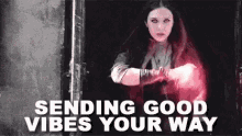 scarlet witch is sending good vibes your way with a glowing light coming out of her hands .