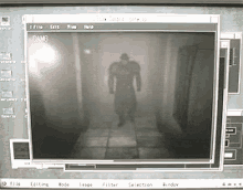 a computer screen shows a shadow of a man walking down a hallway