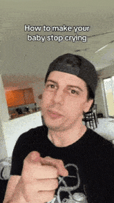 a man wearing a black hat is pointing at the camera with the caption " how to make your baby stop crying " above him