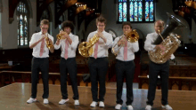 a group of men are playing instruments in a church