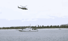 a helicopter is flying over a boat in the ocean