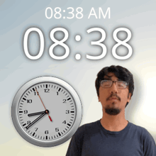 a man wearing glasses stands in front of a clock that says ' 0:38 am ' on it