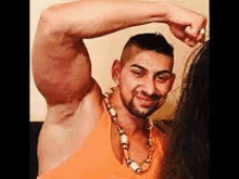 a man with a very large biceps is standing next to a woman and holding her hair .