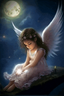 a little girl with angel wings sitting on a rock with a candle