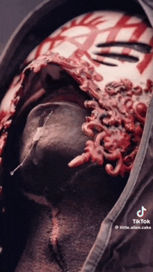 a close up of a person 's face with a bloody mask on .