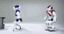 two robots are standing next to each other in front of a trash can with the number 8 on it .