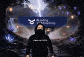 a man wearing a black hoodie that says leading with creativity