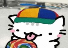 a hello kitty wearing a colorful hat is holding a lollipop .