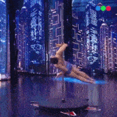 a pole dancer performs on a stage in front of a cityscape