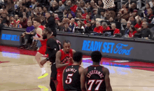 a basketball game is being played in front of a ready set ford advertisement