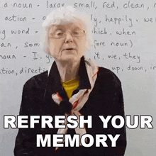 an elderly woman stands in front of a white board with the words " refresh your memory " on it