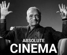 a man sitting in a chair with his hands in the air and the words absolute cinema below him