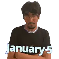 a man wearing glasses and a black shirt with the words january 5 written on it