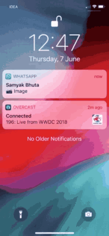 a phone screen shows a notification for whatsapp