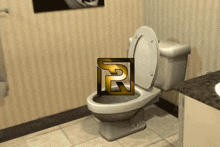 a toilet in a bathroom with the letter r on the bottom