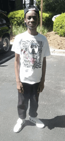 a young man wearing a white shirt with a star wars logo