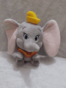 a stuffed elephant with a yellow hat on top