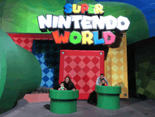 a family poses for a photo in front of a super nintendo world sign