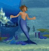 a shirtless man with a mermaid tail is standing in the water .
