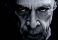 a close up of a man 's face in a black and white photo