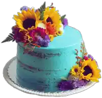 a blue cake decorated with sunflowers and other flowers