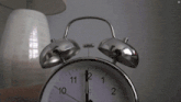 a person laying on a bed next to an alarm clock that says slotto af