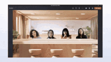 a group of women are sitting at a table in front of a computer screen that says teams