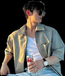 a man wearing sunglasses is holding a diet coke can