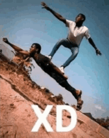 two men are doing a trick on a skateboard with the word xd written on the bottom .