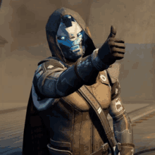 a video game character giving a thumbs up while wearing a hood