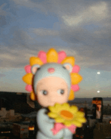 a doll wearing a lion costume holding a flower