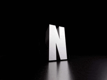 a white letter n is on a black surface