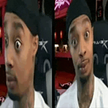 a man wearing a hat and a white shirt is making a funny face while sitting in a chair .