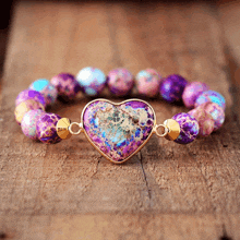 a purple heart shaped bracelet with purple beads