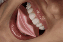 a close up of a woman 's mouth with a pink lip