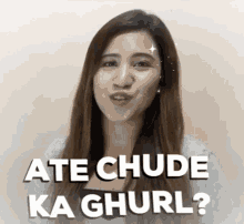 a woman is making a funny face with the words ate chude ka ghurl written on her face .