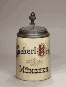 a ceramic jar with a lid that says cacherl-brau munchen